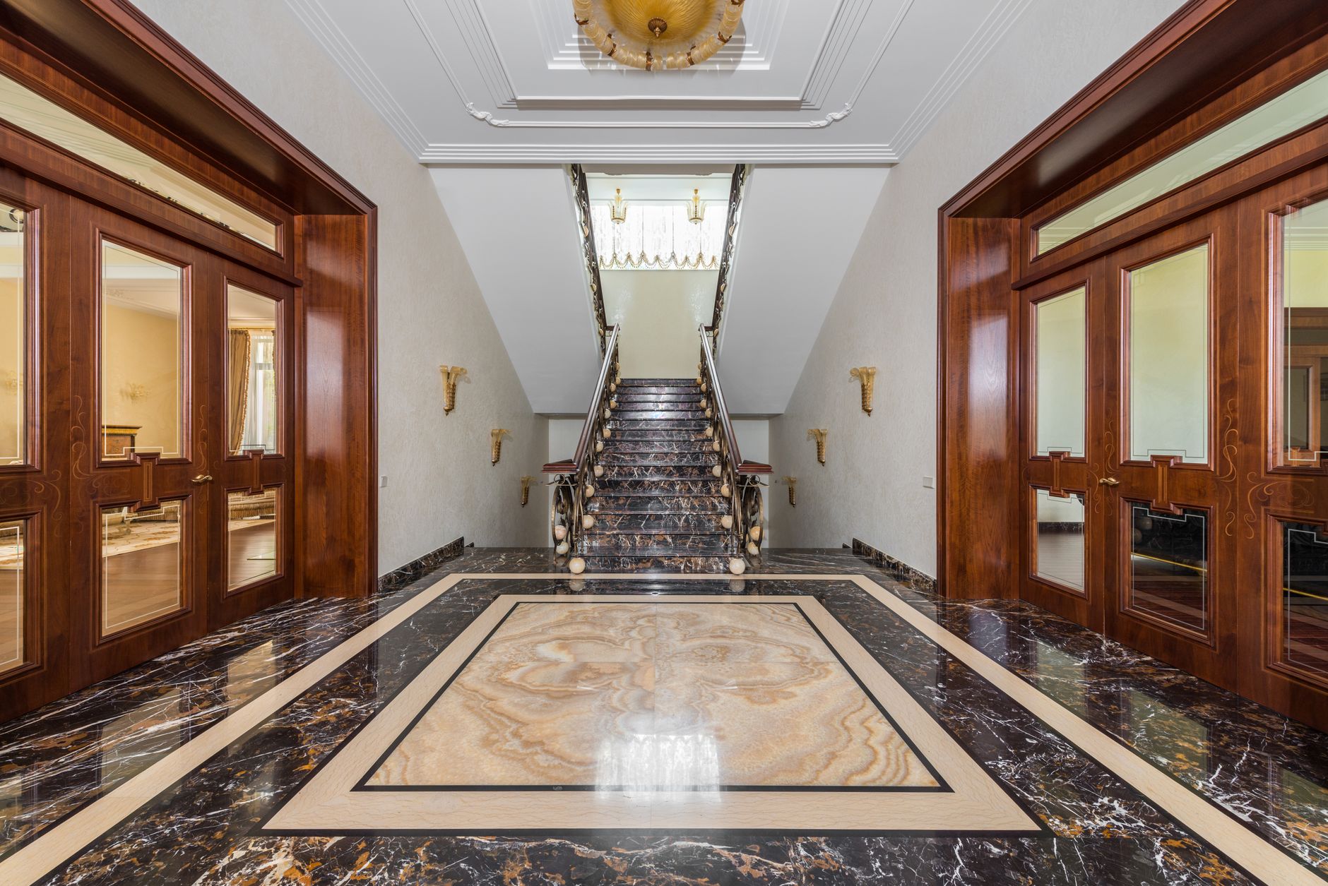 Interior of spacious corridor with marble floor and stairway in luxury apartment in daylight in Riverside, CA